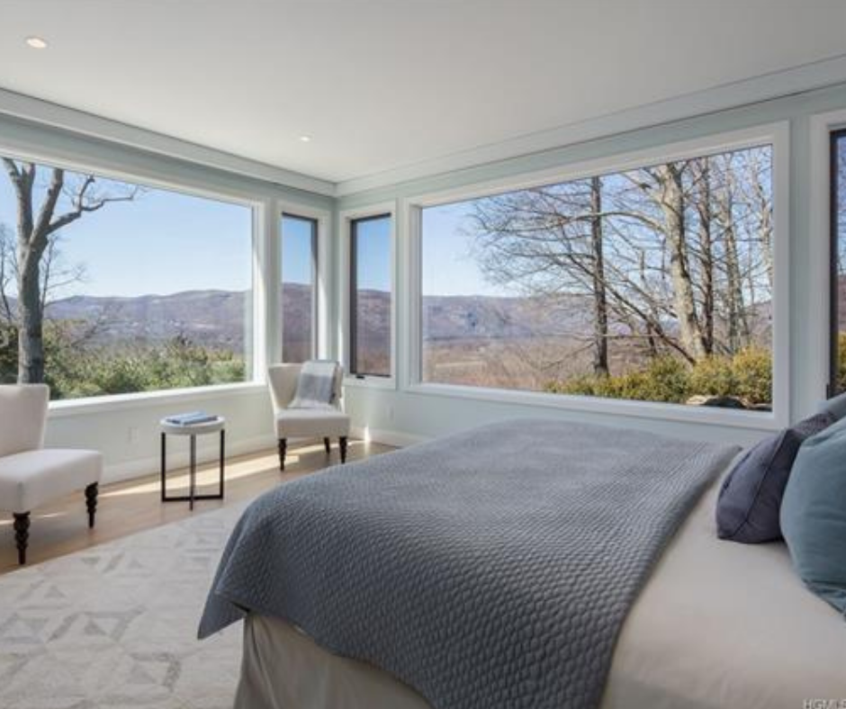 The master bedroom suite on the main floor is enhanced by a stunning view, plus wrap around decking.